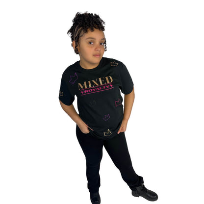 Mixed-race girl wearing a black 'Mixed Royalty' shirt with gold and purple sparkle lettering and sparkle crowns randomly all over. Youth empowerment fashion promoting biracial pride.